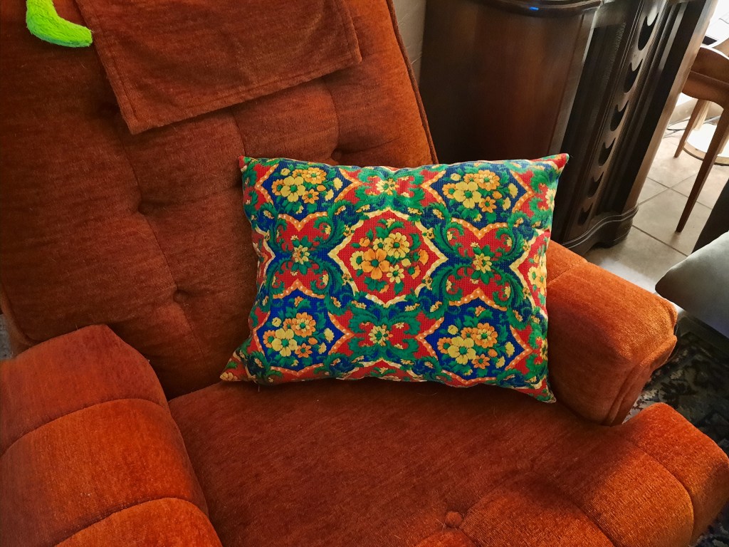 The finished homemade wool pillow with a zipped cover made with vintage Alexander Henry designer fabric