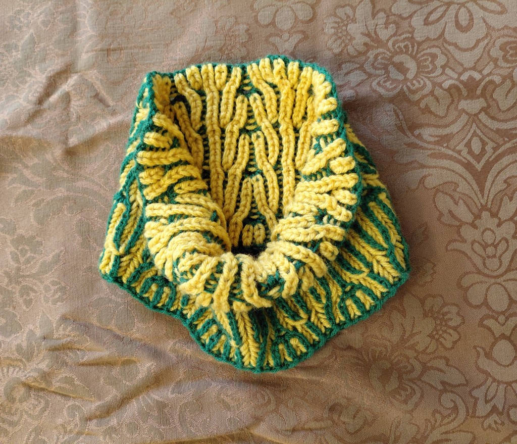 a reversible green and gold neck cowl or headband for winter
