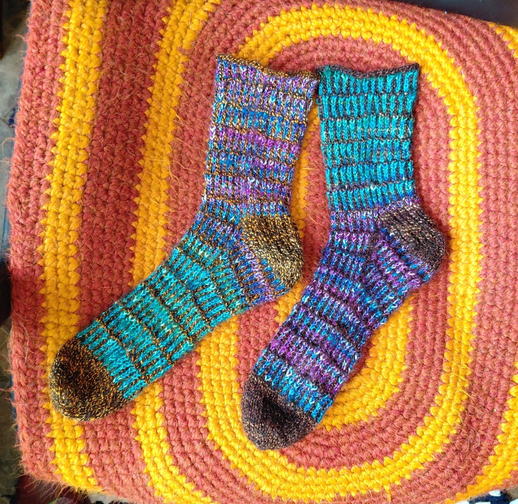 a pair of wool Dragon Scale socks in purple and turquoise blue
