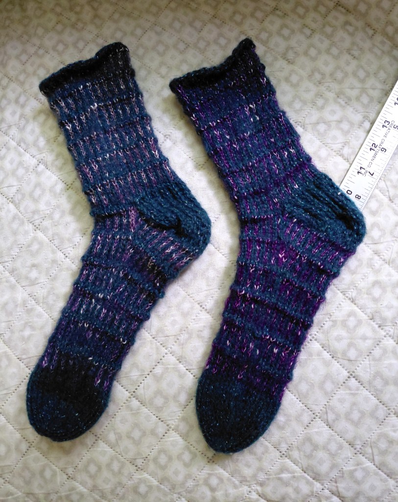 Handknit Dragon Scale Socks knit in vintage sparkly turquoise wool, silk, and stellina yarn and poly yarn with wool and silk.